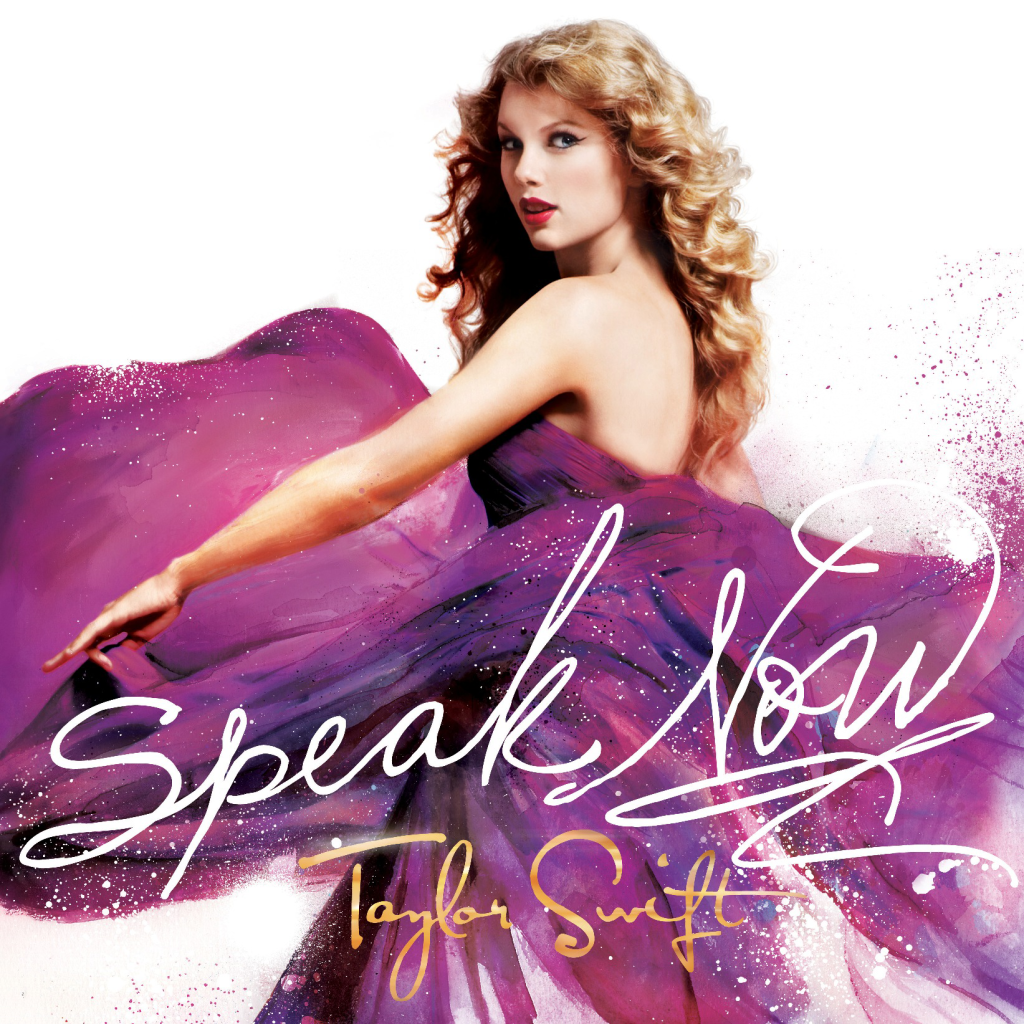 The cover art for Speak Now. Taylor Swift wears a purple ballgown which flows out around her and the words Speak Now appear in white in handwriting in front of her.